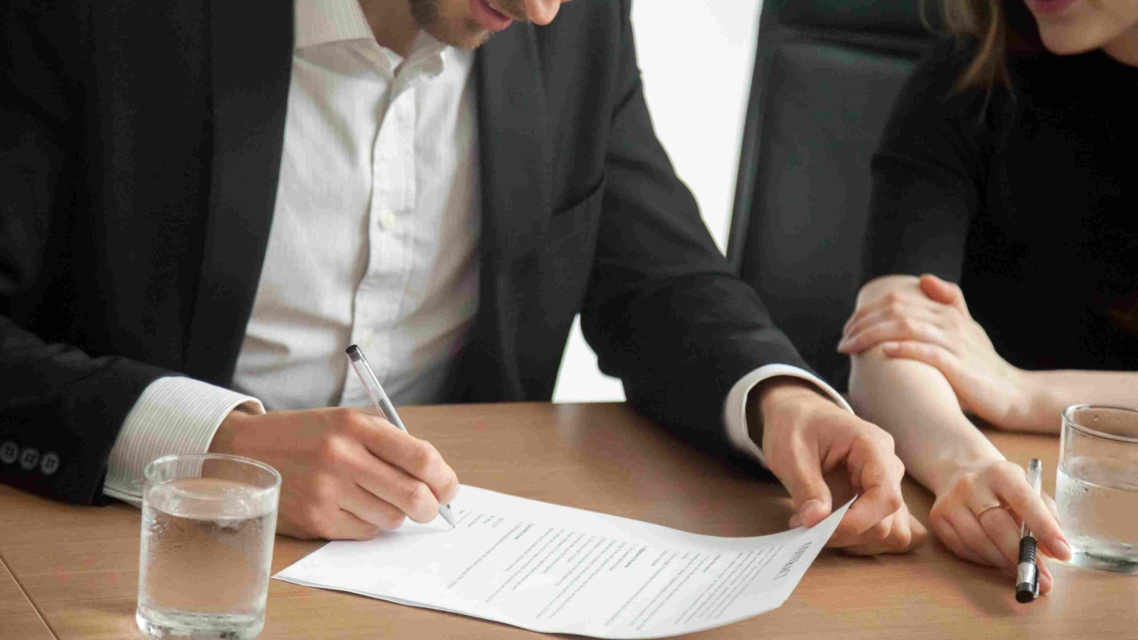 satisfied-smiling-businessman-suit-signing-contract-meeting-concept_11zon