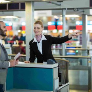 airline-check-attendant-showing-direction-commuter-check-counter_11zon (1)